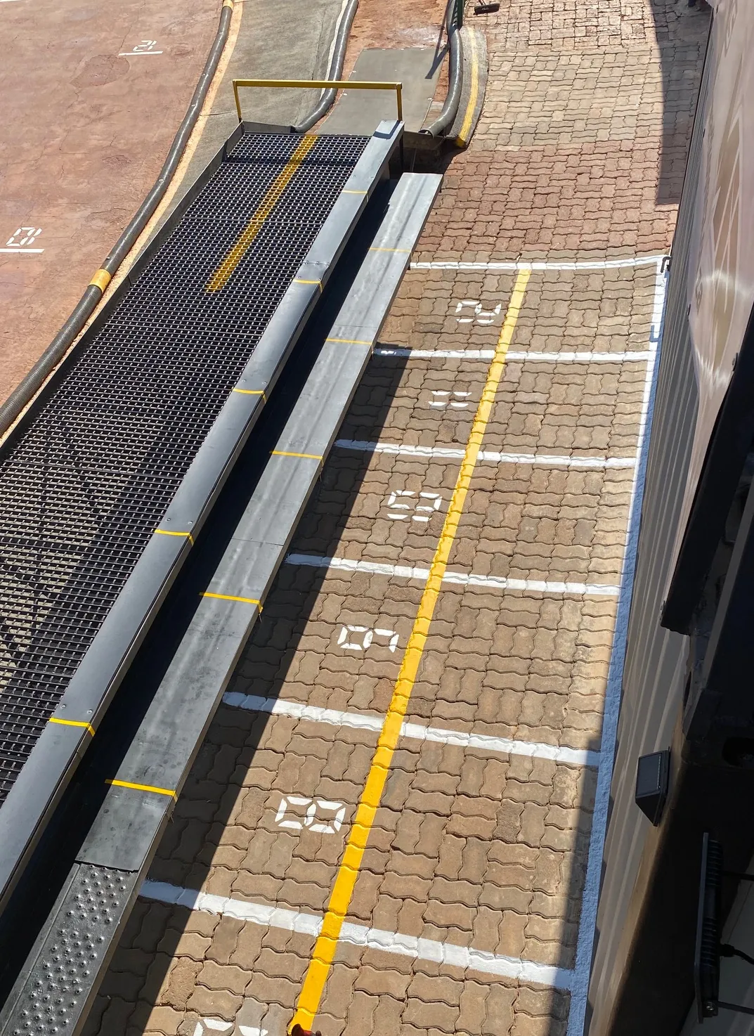Numbered pit boxes and the yellow line in the pit lane
